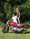 Little girl standing on motorbike