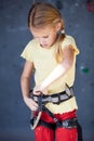 Little girl standing near a climbing rock wall indoor. Royalty Free Stock Photo