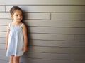 Little girl standing over modern brick