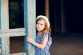 Little girl standing on porch of old ruined house. Royalty Free Stock Photo