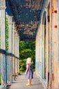 Little girl standing on porch of old ruined house. Royalty Free Stock Photo
