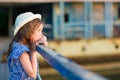 Little girl standing on porch of old ruined house. Royalty Free Stock Photo