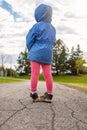 Little girl standing on a road in the park in spring. Child from behind Royalty Free Stock Photo