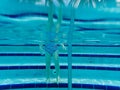 A little girl standing on the steps of swimming pool Royalty Free Stock Photo