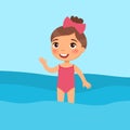 Little girl standing in a swimsuit flat vector illustration. Beautiful child having fun in water, waving hand.