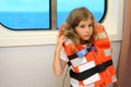 Little girl stands in cabin of ship Royalty Free Stock Photo