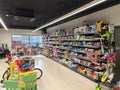 Budva, Montenegro - 13 august 2023: Little girl stands in the children section of the supermarket near the shelves with