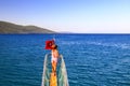 A little girl stands near the Turkish flag on the bow of the ship, sailing along the Aegean Sea Royalty Free Stock Photo