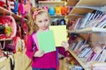 Little girl stands in school department of store Royalty Free Stock Photo