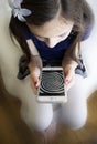 Little girl staring at hypnosis spiral on her cell phone Royalty Free Stock Photo