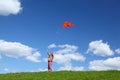 Little girl starts air serpent in sky Royalty Free Stock Photo