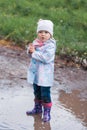 Little girl staying in the puddle and looking at the left Royalty Free Stock Photo