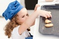 Little girl stealing cookies