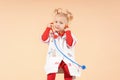 A little girl with a stethoscope plays doctor Royalty Free Stock Photo