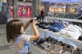 A little girl in a store buys shoes. Shopping, sale Royalty Free Stock Photo