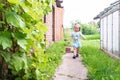 Little girl with strawberry. Outdoor sunny strawberry harvest concept. Fresh eco organic strawberry. New harvest, diet