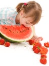 Little girl with strawberry and watermelon Royalty Free Stock Photo