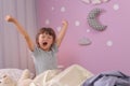 Little girl stretching in bed at home. Time to sleep Royalty Free Stock Photo