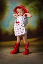 Little girl stretching in red dress