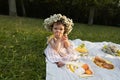 Little girl in a striped dress on a picnic in a city park