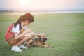 The little girl is stroking her dog with gently and friendly, showing love and care of pet Royalty Free Stock Photo