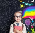 Little girl student on blackboard background Royalty Free Stock Photo