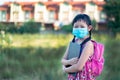 Little girl student wearing face mask during she going back to school after covid-19 quarantine with happy and smile Royalty Free Stock Photo