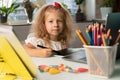a little girl studies at home, returns to school, the child draws on a graphic tablet Royalty Free Stock Photo