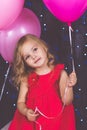 Little girl in studio with pink balloons Royalty Free Stock Photo