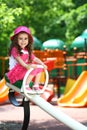 The little girl in stylish dress sitting near the Royalty Free Stock Photo