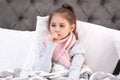 Little girl suffering from cough and cold in bed