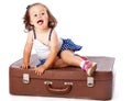 A little girl on the suitcase