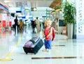 Little girl with suitcase travel in the airport Royalty Free Stock Photo