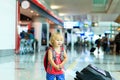 Little girl with suitcase travel in the airport Royalty Free Stock Photo
