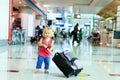 Little girl with suitcase travel in the airport Royalty Free Stock Photo