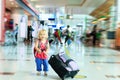 Little girl with suitcase travel in the airport Royalty Free Stock Photo