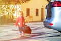 Little girl with suitcases travel by car, family tourism