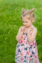 little girl in a summer dress, bad mood Royalty Free Stock Photo