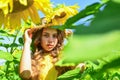 little girl in sunflower field. yellow flower of sunflower. happy childhood. beautiful girl wear straw summer hat in Royalty Free Stock Photo