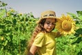 Little girl sunflowers field blue sky background, childhood at village