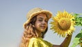 Little girl sunflowers field blue sky background, rustic style