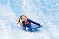 Little girl surfing in beach wave simulator Royalty Free Stock Photo