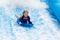 Little girl surfing in beach wave simulator Royalty Free Stock Photo