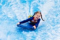 Little girl surfing in beach wave simulator Royalty Free Stock Photo