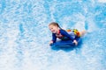 Little girl surfing in beach wave simulator