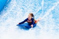 Little girl surfing in beach wave simulator Royalty Free Stock Photo