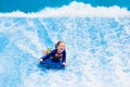 Little girl surfing in beach wave simulator Royalty Free Stock Photo