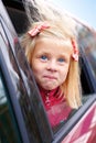 Little girl surprise stares out of the car