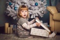Little girl surprised with big present near the christmas tree Royalty Free Stock Photo