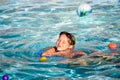 Little girl swimming herself in pool outdoors in summer. Pretty little girl swimming in outdoor pool and have a fun with Royalty Free Stock Photo